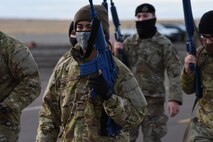 A convoy team leader leads a group of security forces defenders as they patrol the road on high alert for unidentified explosive devices and any other possible threat to the mission.