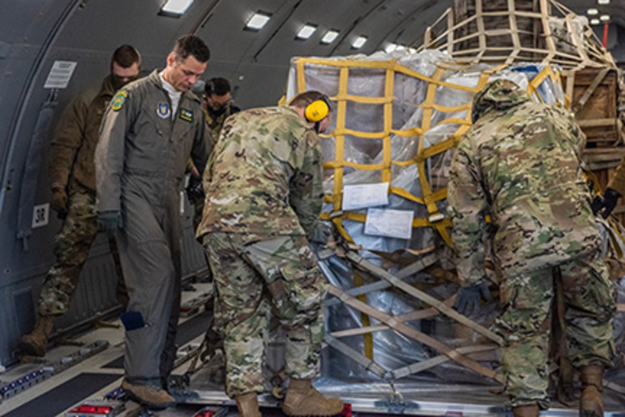 Tech. Sgt. Chris Davis, a boom operator from the 916th Air Refueling Wing, assists 67th Aerial Port Squadron reservists with locking a pallet down in a KC-46A Pegasus, Jan. 10, 2021, at Hill Air Force Base, Utah.