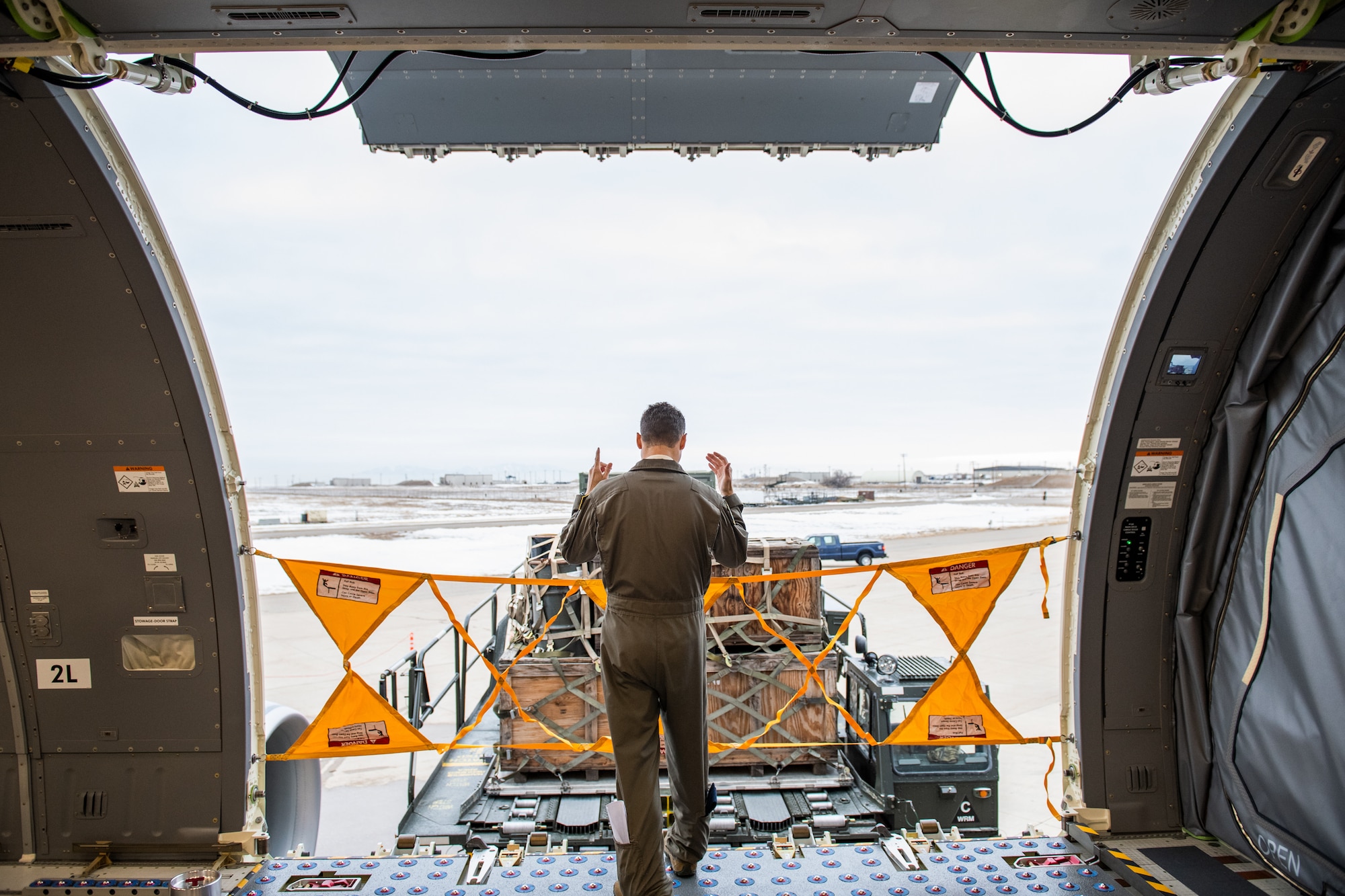 Tech. Sgt. Chris Davis, a boom operator from the 916th Air Refueling Wing, marshals a Tunner 60K aircraft cargo loader during a training exercise, Jan 10, 2021, at Hill Air Force Base, Utah.