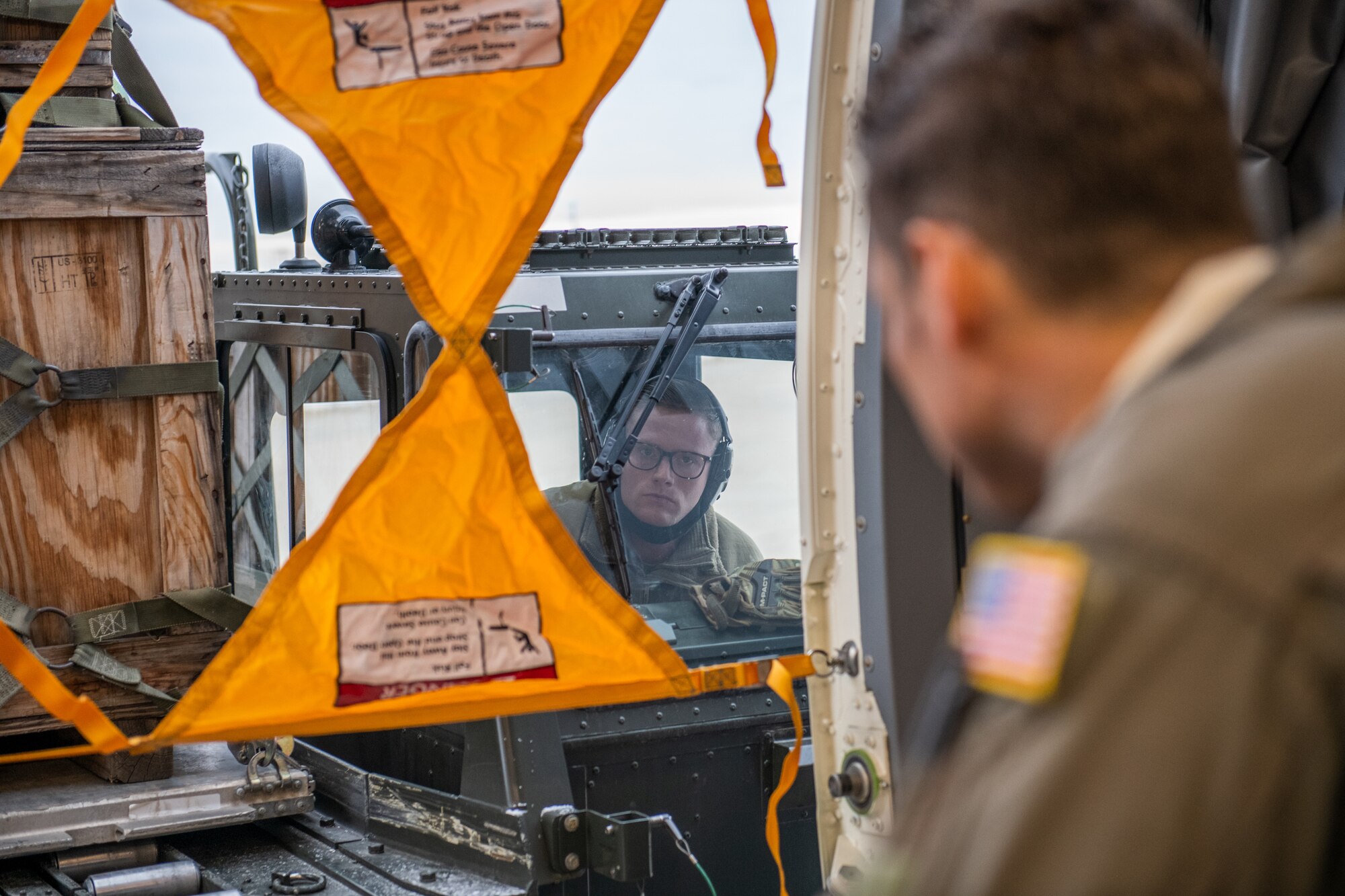 Tech. Sgt. Chris Davis, a boom operator from the 916th Air Refueling Wing, marshals Staff Sgt. Todd Rimmasch, an air transportation specialist in the 67th Aerial Port Squadron, in docking an aircraft cargo loader, Jan. 10, 2021, at Hill Air Force Base, Utah.