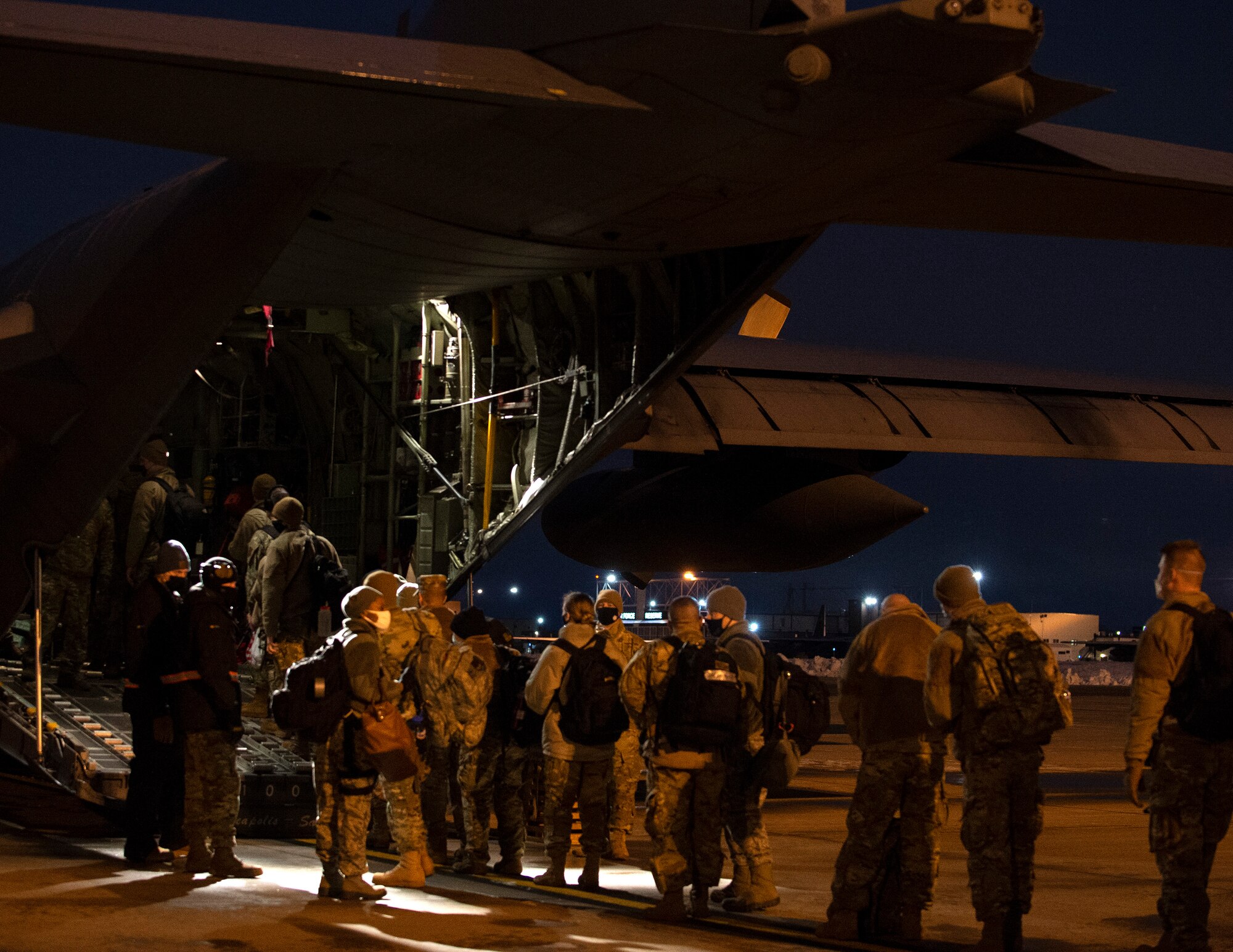 U.S. Air Force Airmen from the 133rd Airlift Wing board a C-130 Hercules in St. Paul, Minn., Jan. 18, 2021.