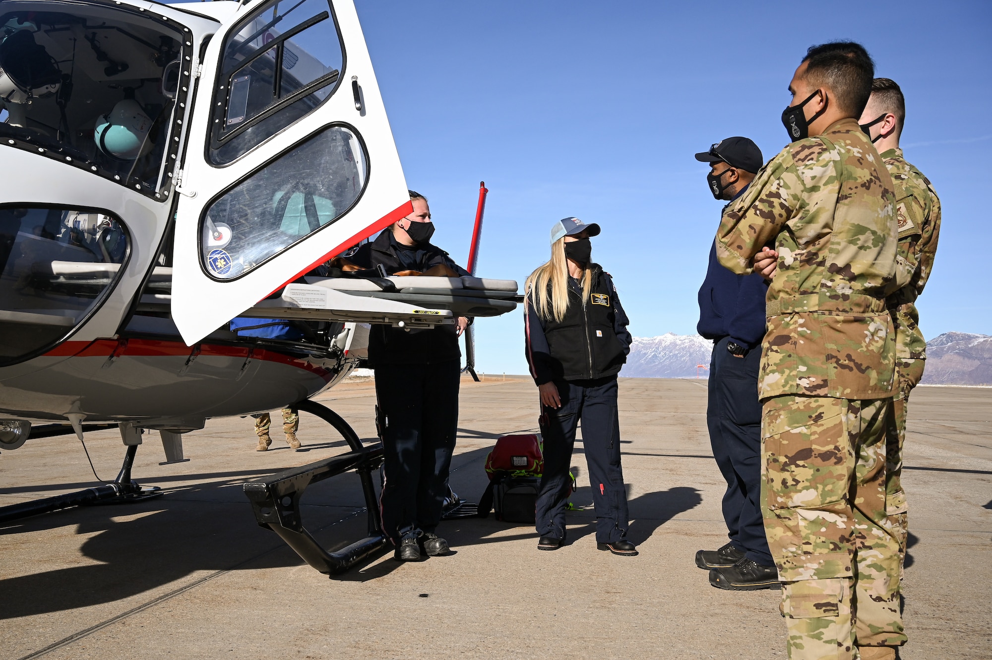 Erica Rau (left) and Crystal Causey, AirLife Utah trauma clinicians, speak with Hill firefighters during an air ambulance training event at Hill Air Force Base, Utah, Jan. 14. 2021. Hill's first responders conduct the annual training to remain proficient on air ambulance operations. The Ogden AirLife Utah base is located at Ogden Regional Medical Center. (U.S. Air Force photo by R. Nial Bradshaw)