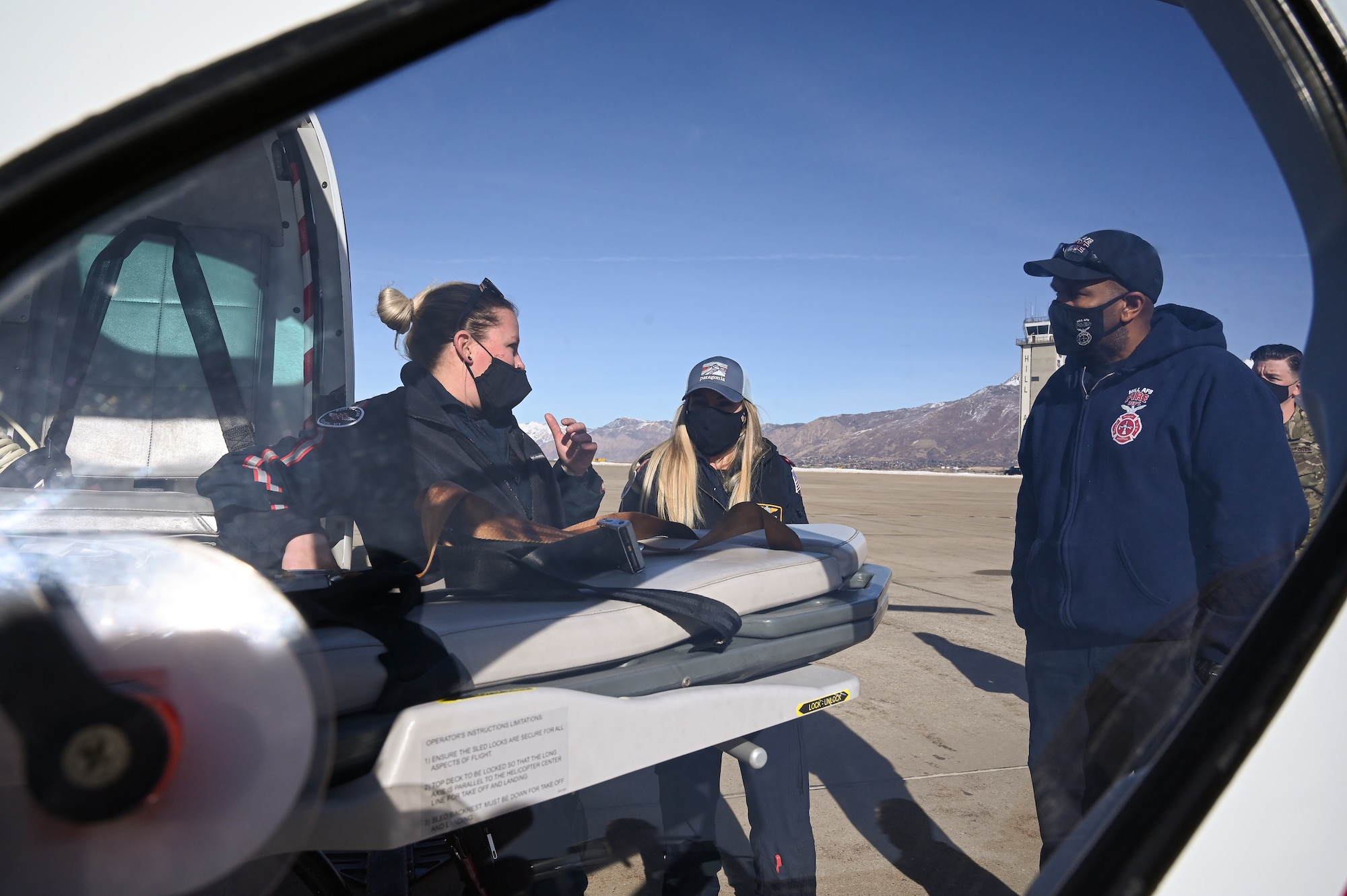 Erica Rau (left) and Crystal Causey, AirLIfe Utah trauma clinicians, speak with Zack Olds, Hill firefighter, during an air ambulance training event at Hill Air Force Base, Utah, Jan. 14. 2021. Hill's first responders conduct the annual training to remain proficient on air ambulance operations. The Ogden AirLIfe Utah base is located at Ogden Regional Medical Center. (U.S. Air Force photo by R. Nial Bradshaw)
