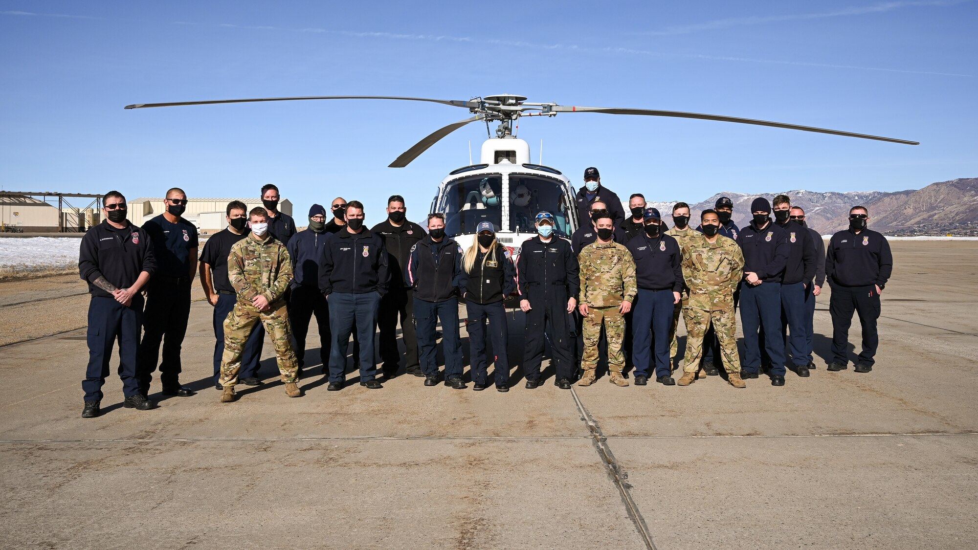 An AirLIfe Utah air ambulance crew and Hill firefighters pose for a group photo during an air ambulance training event at Hill Air Force Base, Utah, Jan. 14. 2021. Hill's first responders conduct the annual training to remain proficient on air ambulance operations. The Ogden AirLIfe Utah base is located at Ogden Regional Medical Center. (U.S. Air Force photo by R. Nial Bradshaw)