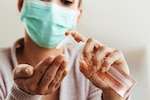 Woman using antibacterial hand gel