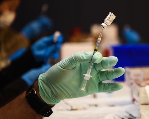 U.S. Air Force Lt. Col. Roy Loque, 17th Operational Medical Readiness Squadron commander, readies a COVID-19 vaccination at the Mathis Fitness Center on Goodfellow Air Force Base, Texas, Jan. 20, 2021. Team Goodfellow vaccinated its frontline and mission essential positions, and those who are considered high risk first, in accordance with the Department of the Air Force’s distribution plan. (U.S. Air Force photo by Senior Airman Abbey Rieves)