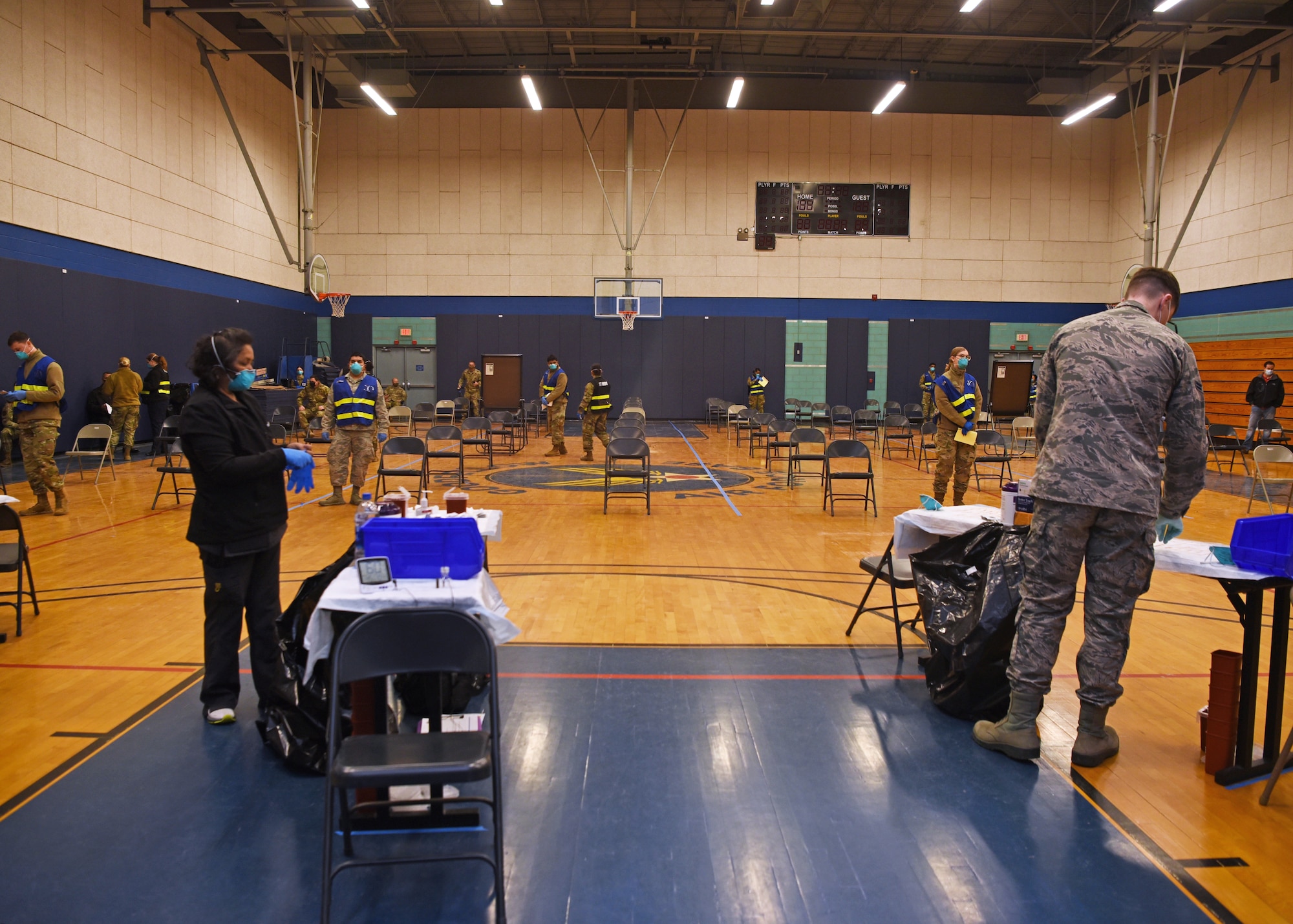 Members of the 17th Medical Group organize the Mathis Fitness Center to host the first COVID-19 immunization clinic on Goodfellow Air Force Base, Texas, Jan. 20, 2021. The 17th MDG managed the program to ensure the maximum number of priority group volunteers were vaccinated safely and efficiently. (U.S. Air Force photo by Senior Airman Abbey Rieves)