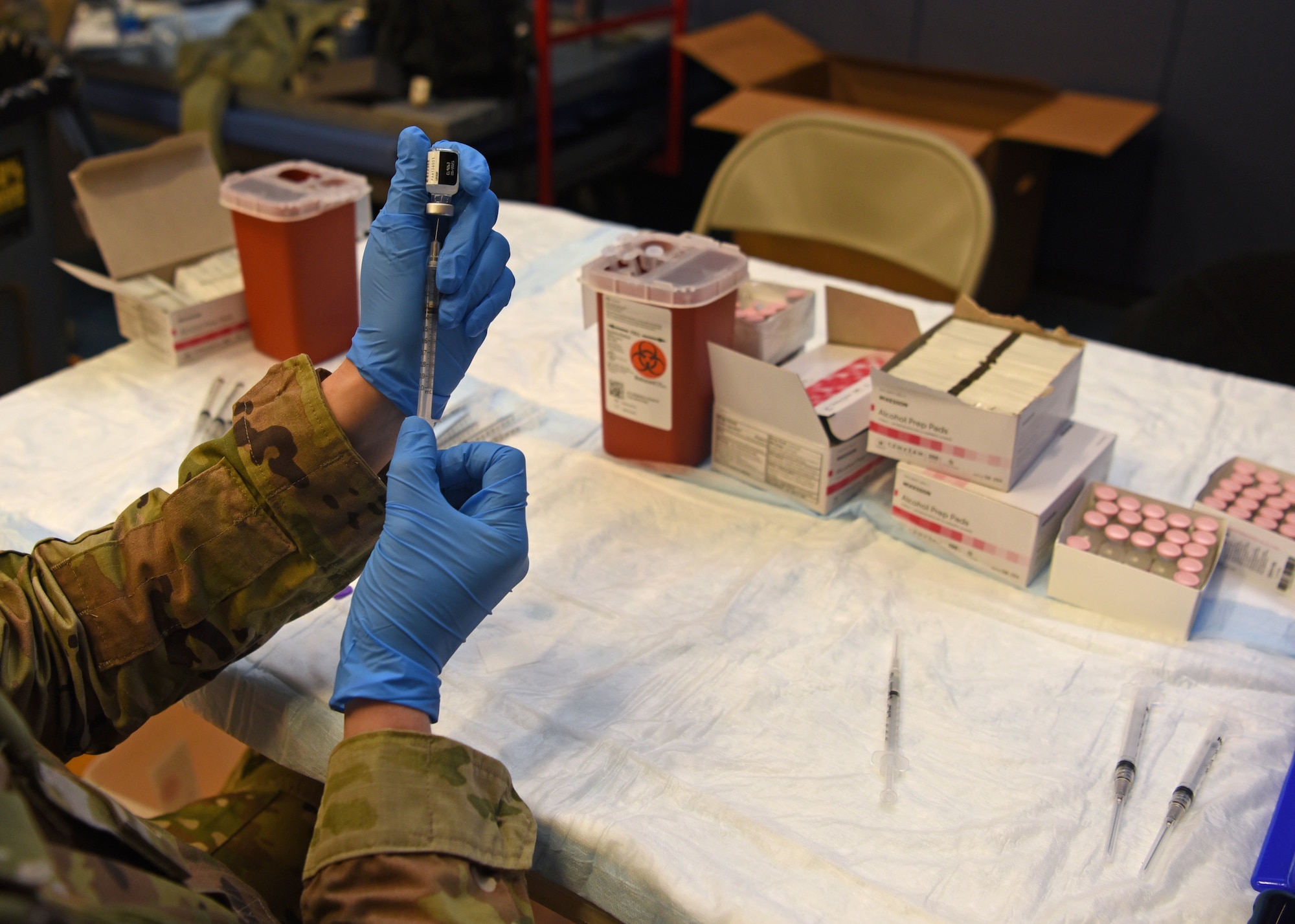 U.S. Air Force Master Sgt. Dianna Karas, 17th Healthcare Operations Squadron family health flight chief, reconstitutes the COVID-19 vaccine in preparation for the immunization clinic hosted at the Mathis Fitness Center on Goodfellow Air Force Base, Texas, Jan. 20, 2021. The vaccine is authorized for emergency use but is voluntary until the Food and Drug Administration fully approves it. (U.S. Air Force photo by Senior Airman Abbey Rieves)