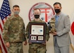 Lt. Col. Matthew Levine, commander of Public Health Activity-Japan, presented representatives of SARS Team Six, Maj. Bradley Kearney, a biochemist and former Public Health Command-Pacific Laboratory Sciences director, and Gary Crispell, a PHC-P microbiologist, the 4th Quarter and Fiscal Year 2020 Wolf Pack Awards for their support as the lead clinical testing team for COVID-19 for U.S. Forces Japan during a virtual ceremony Jan. 20, 2020, at Camp Zama, Japan. The Wolf Pack Award recognizes exceptional teamwork by an integrated group of military and civilian team members focused on excellence in support of Army Medicine. (Photo by Momoko Shindo)