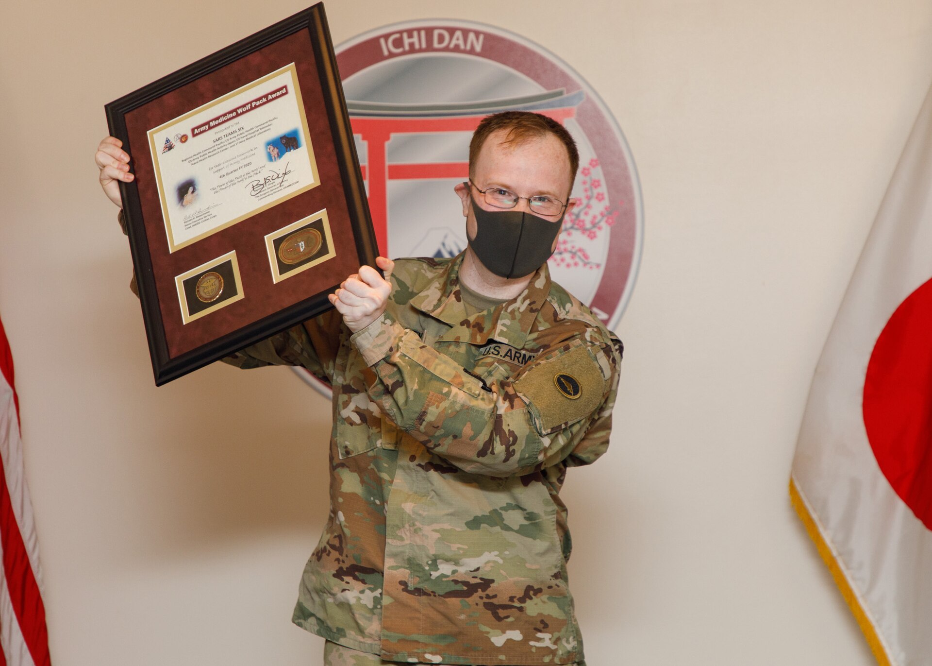 Maj. Bradley Kearney, a biochemist and former Public Health Command-Pacific Laboratory Sciences director, accepts the 4th Quarter Wolf Pack Award on behalf of SARS Team Six during a virtual ceremony Jan. 20, 2020, at Camp Zama, Japan. The Wolf Pack Award recognizes exceptional teamwork by an integrated group of military and civilian team members focused on excellence in support of Army Medicine. (Photo by Momoko Shindo)