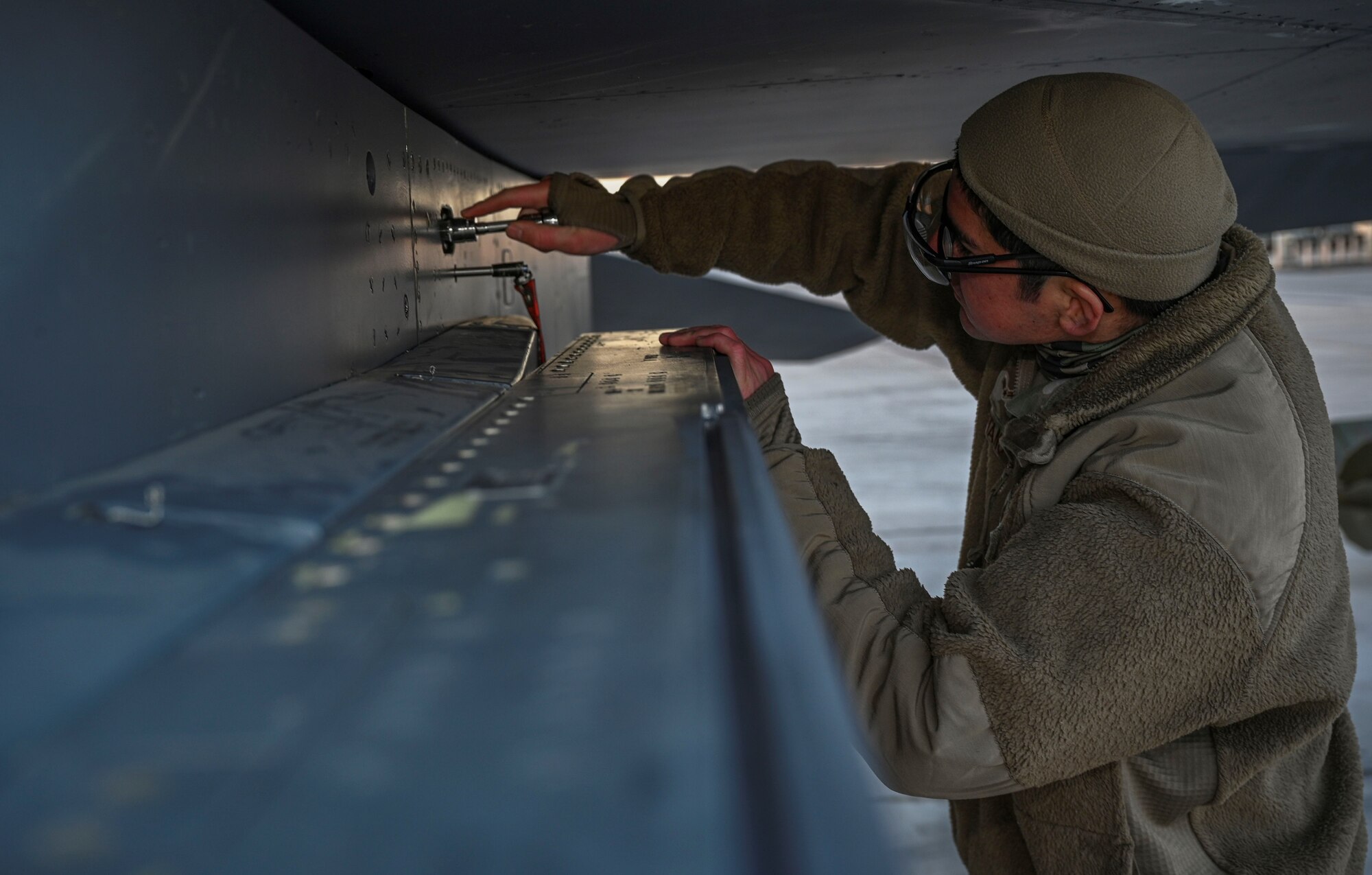 Airman works on aircraft.