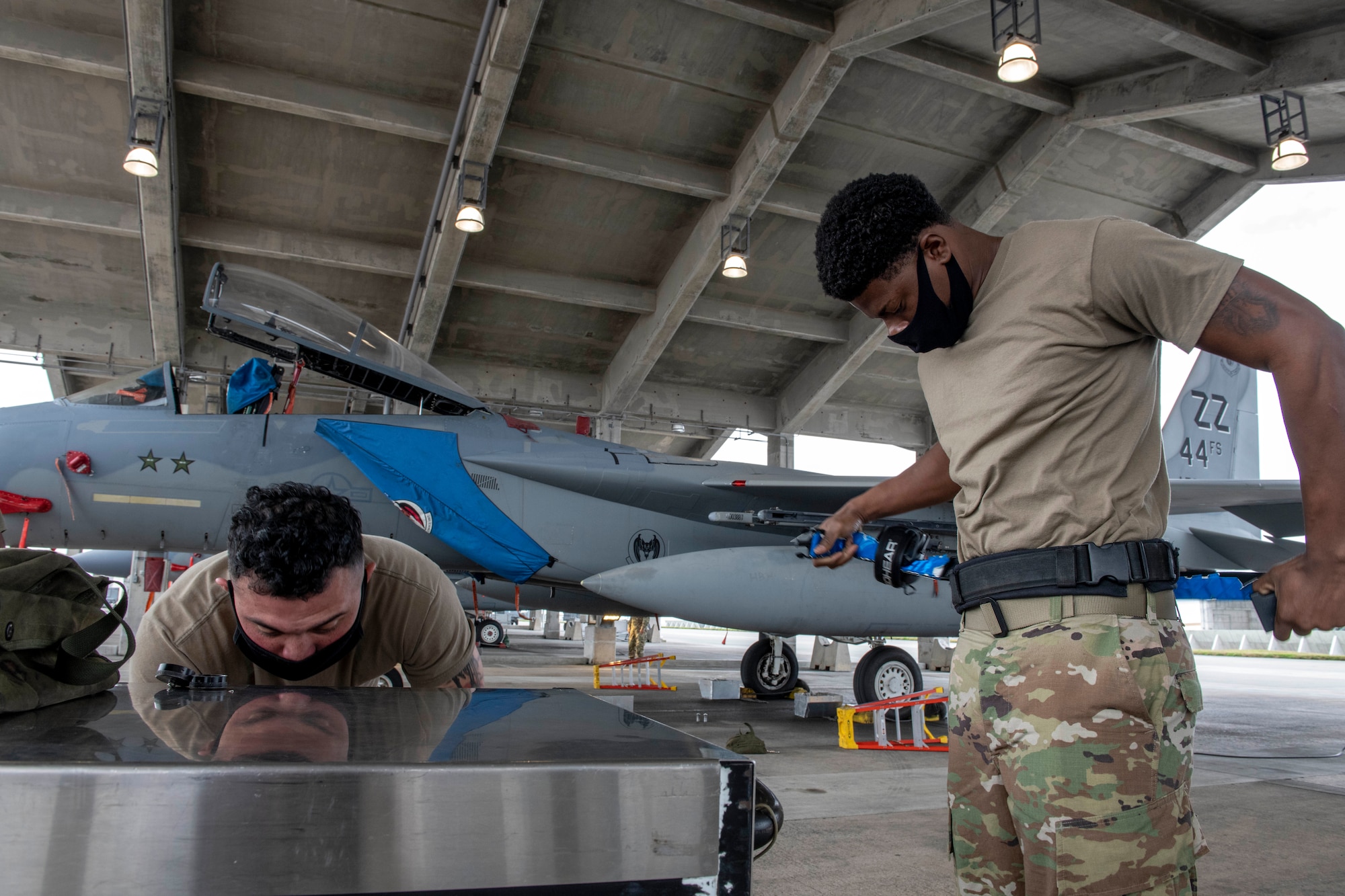 The 44th Aircraft Maintenance Unit load crew members prepare for the quarterly weapons load competition at Kadena Air Base, Japan, Jan. 14, 2021. This competition featured two teams competing for the 18th Wing’s best load crew. (U.S. Air Force photo by Naoto Anazawa)