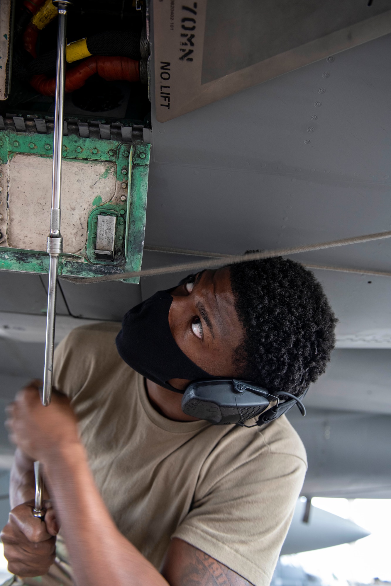 U.S. Air Force Senior Airman Tyree Singleton, 44th Aircraft Maintenance Unit weapons load crew member, tightens a screw during the quarterly weapons load competition at Kadena Air Base, Japan, Jan. 14, 2021. Weapons load crew competitions are held each quarter and annually in order to boost morale and highlight superior performers among the load crew teams. (U.S. Air Force photo by Naoto Anazawa)