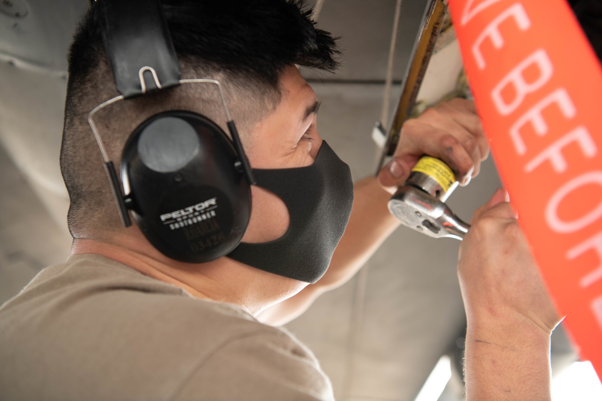 U.S. Air Force Airman 1st Class Robert Garcia, a weapons load crew member, from the 67th Aircraft Maintenance Unit, competes in the quarterly load competition at Kadena Air Base, Japan, Jan. 15, 2021. The 67th AMU won the quarterly load competition against the 44th AMU. (U.S. Air Force photo by Airman First Class Stephen Pulter)