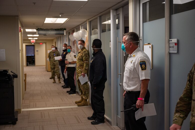 Members from Team Dover wait to receive the COVID-19 vaccine at Dover Air Force Base, Jan. 15, 2021. This is the first batch of vaccines to arrive at Dover AFB and will be distributed in a three-phase process starting with healthcare providers, healthcare support workers, frontline workers and safety personnel. The vaccine was granted emergency use authorization by the U.S. Food and Drug Administration for use in prevention of COVID-19. (U.S. Air Force photo by Airman 1st Class Faith Schaefer)
