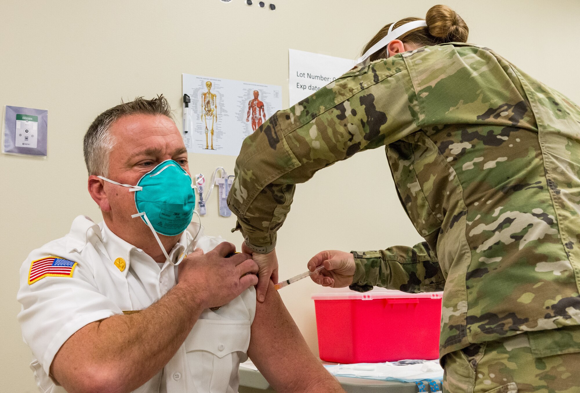 Aaron Weisenberger, 436th Civil Engineer Squadron fire department assistant chief for health and safety, is administered the COVID-19 vaccine by Staff Sgt. Kelsey Loeser, 436th Medical Group unit training manager, Jan. 15, 2021, at Dover Air Force Base, Delaware. Weisenberger was among the first Team Dover frontline workers who voluntarily received the vaccine in concurrence with Department of Defense guidance. The vaccine was granted emergency use authorization by the U.S. Food and Drug Administration for use in prevention of COVID-19. (U.S. Air Force photo by Roland Balik)