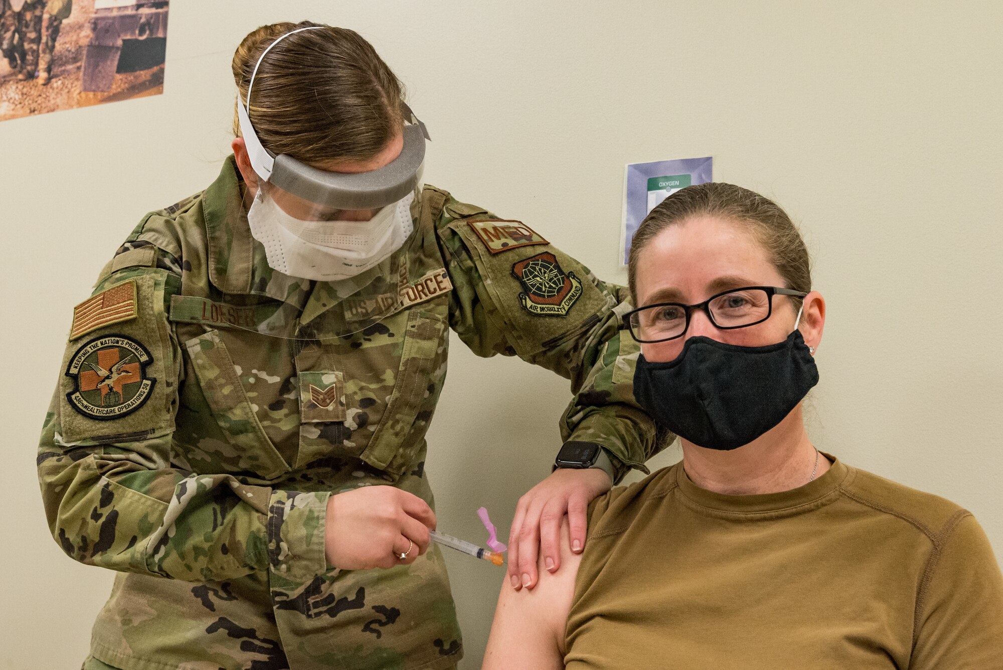 Lt. Col. Brittany Nutt, 436th Health Care Operations Squadron commander, is administered the COVID-19 vaccine by Staff Sgt. Kelsey Loeser, 436th Medical Group unit training manager, Jan. 15, 2021, at Dover Air Force Base, Delaware. Nutt was among the first Team Dover frontline workers who voluntarily received the vaccine in concurrence with Department of Defense guidance. The vaccine was granted emergency use authorization by the U.S. Food and Drug Administration for use in prevention of COVID-19. (U.S. Air Force photo by Roland Balik)