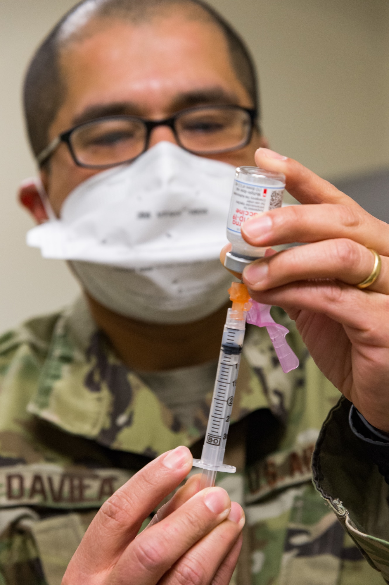 Tech. Sgt. Juan Davila, 436th Operational Medical Readiness Squadron flight operational medicine noncommissioned officer in charge, prepares a single dosage of the COVID-19 vaccine Jan. 15, 2021, at Dover Air Force Base, Delaware. Davila prepared syringes to be administered to the first Team Dover frontline workers who volunteered to receive the vaccine and were identified as eligible in concurrence with Department of Defense guidance. (U.S. Air Force photo by Roland Balik)
