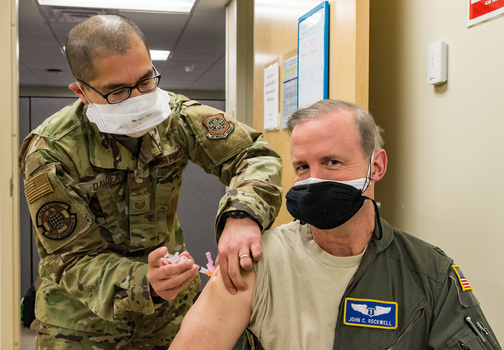 Col. John Rockwell, 436th Medical Group chief of aerospace medicine, is administered the COVID-19 vaccine by Tech. Sgt. Juan Davila, 436th Operational Medical Readiness Squadron flight operational medicine noncommissioned officer in charge, Jan. 15, 2021, at Dover Air Force Base, Delaware. As the 436th Airlift Wing public health emergency officer, Rockwell was among the first Team Dover frontline workers who voluntarily received the vaccine and were identified as eligible in concurrence with Department of Defense guidance. (U.S. Air Force photo by Roland Balik)