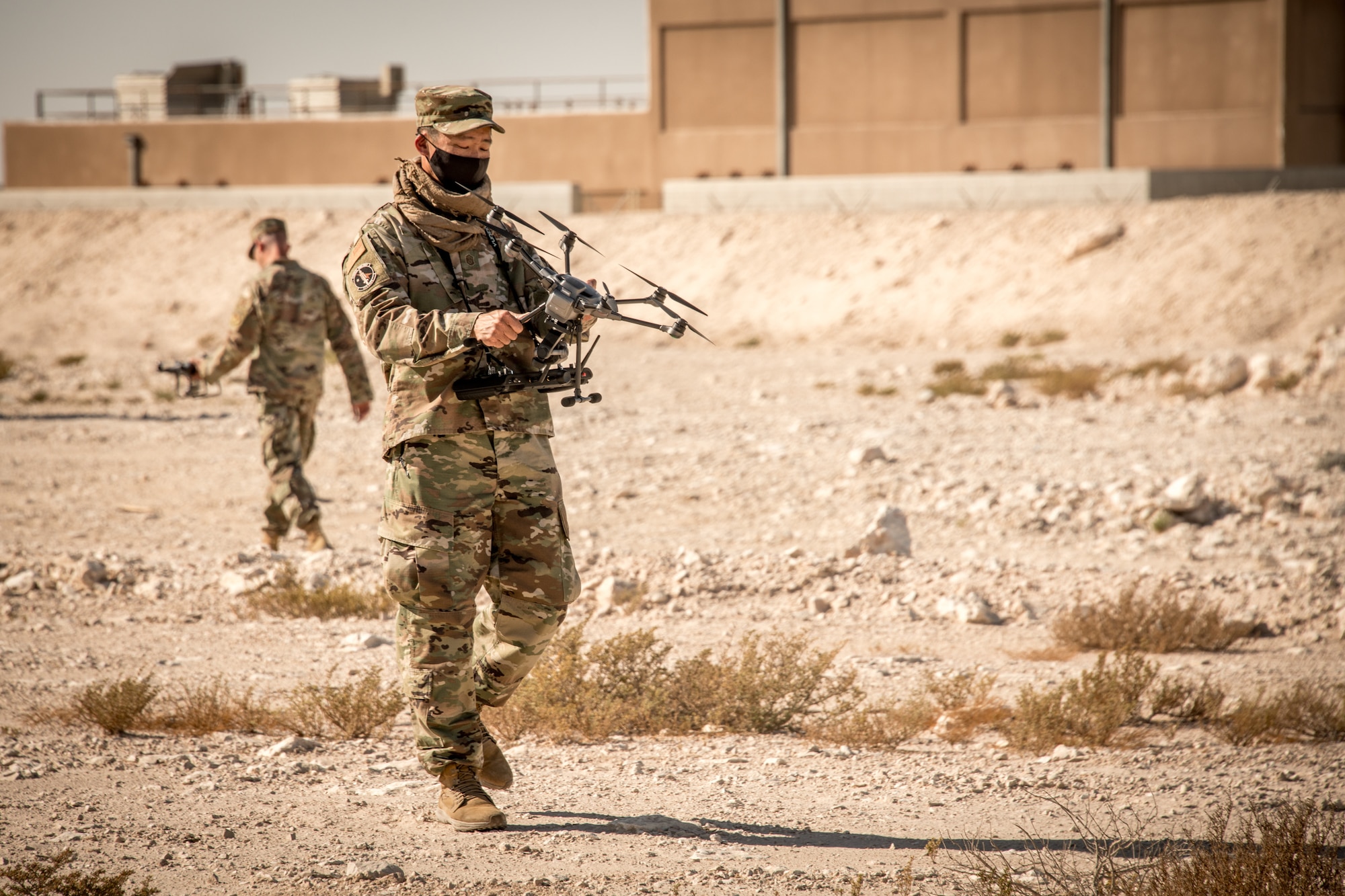 An airman examines a drone