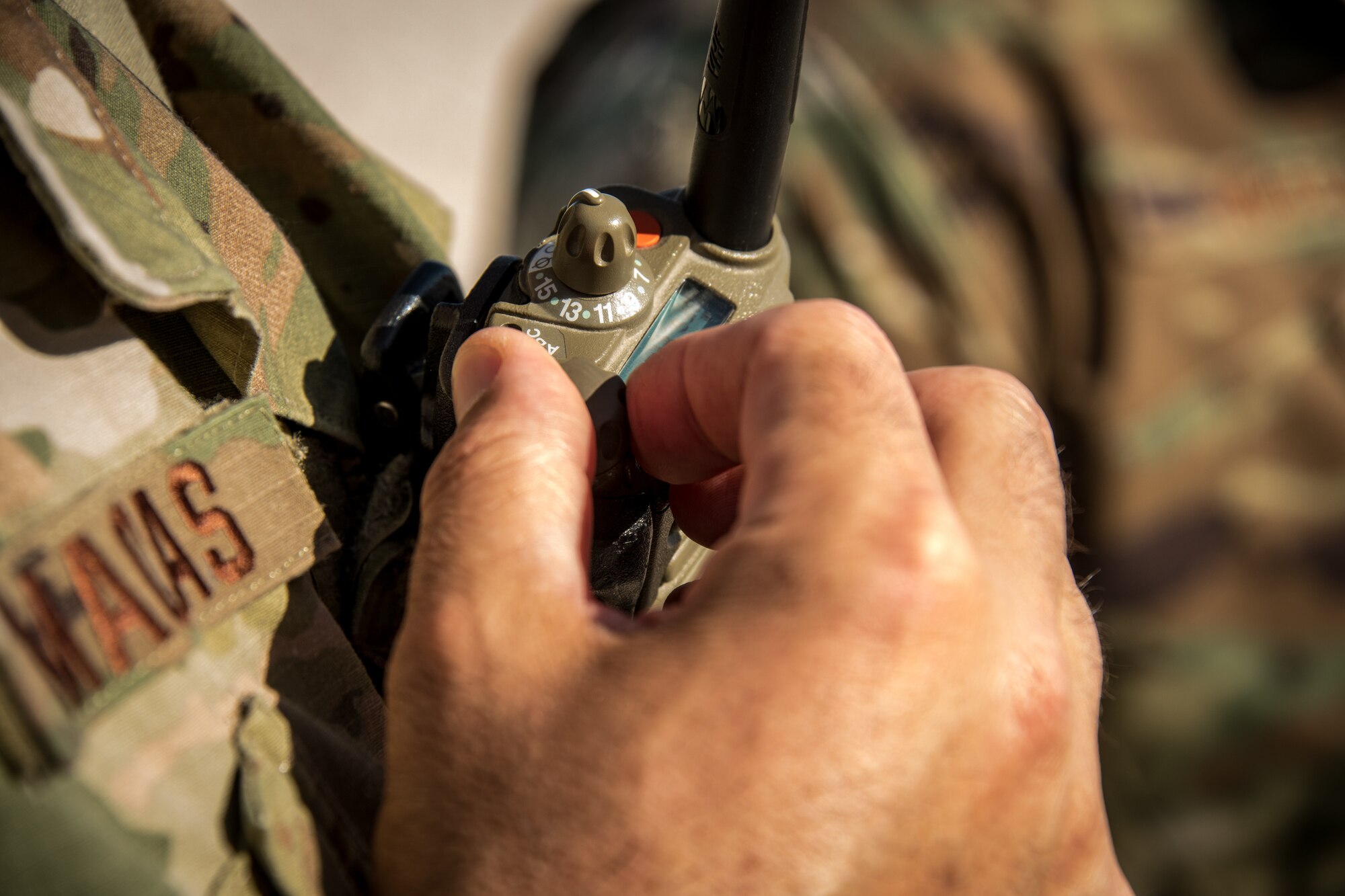 a dial on a portable communications radio is turned