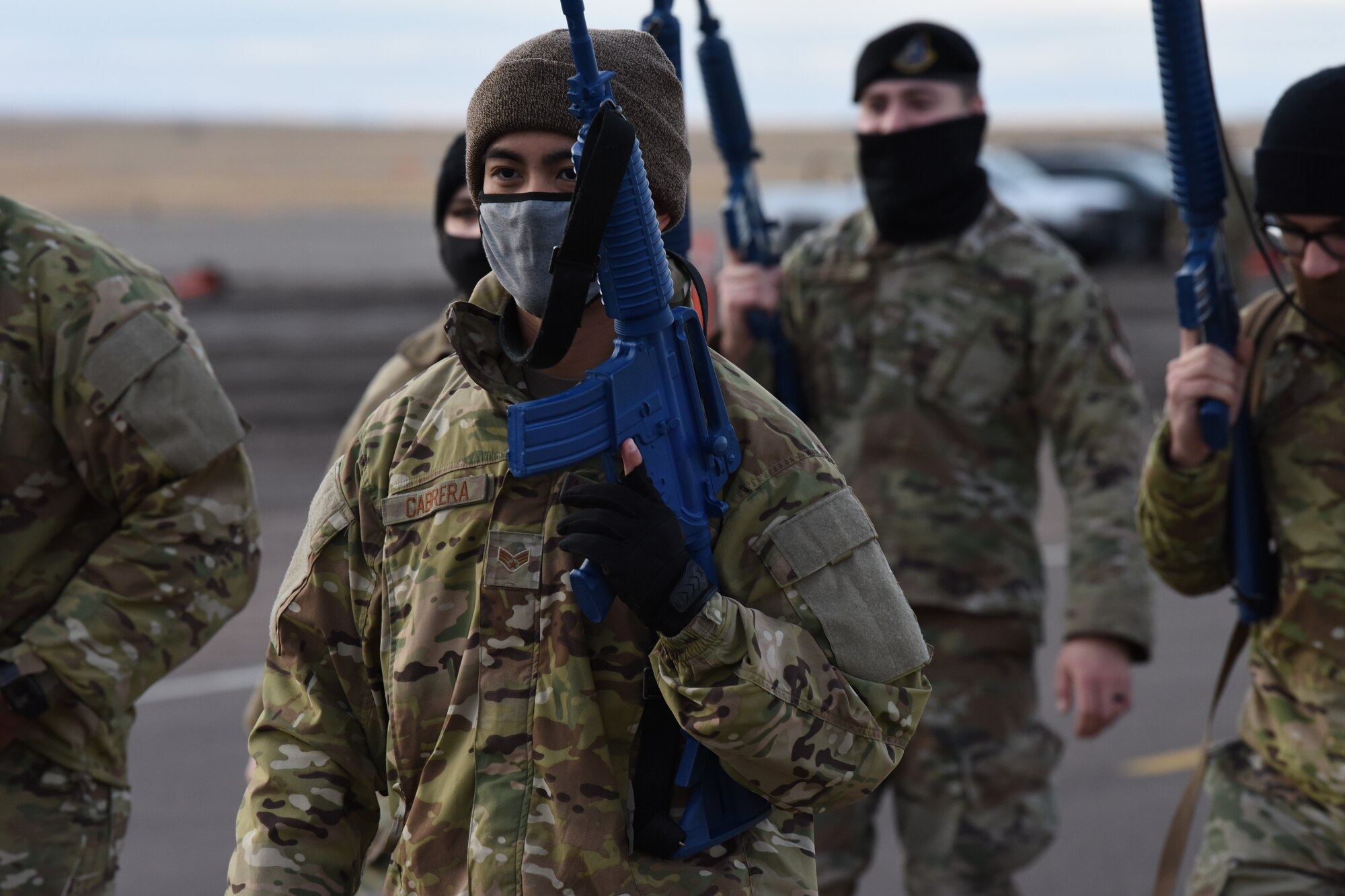 A convoy team leader leads a group of security forces defenders as they patrol the road on high alert for unidentified explosive devices and any other possible threat to the mission.
