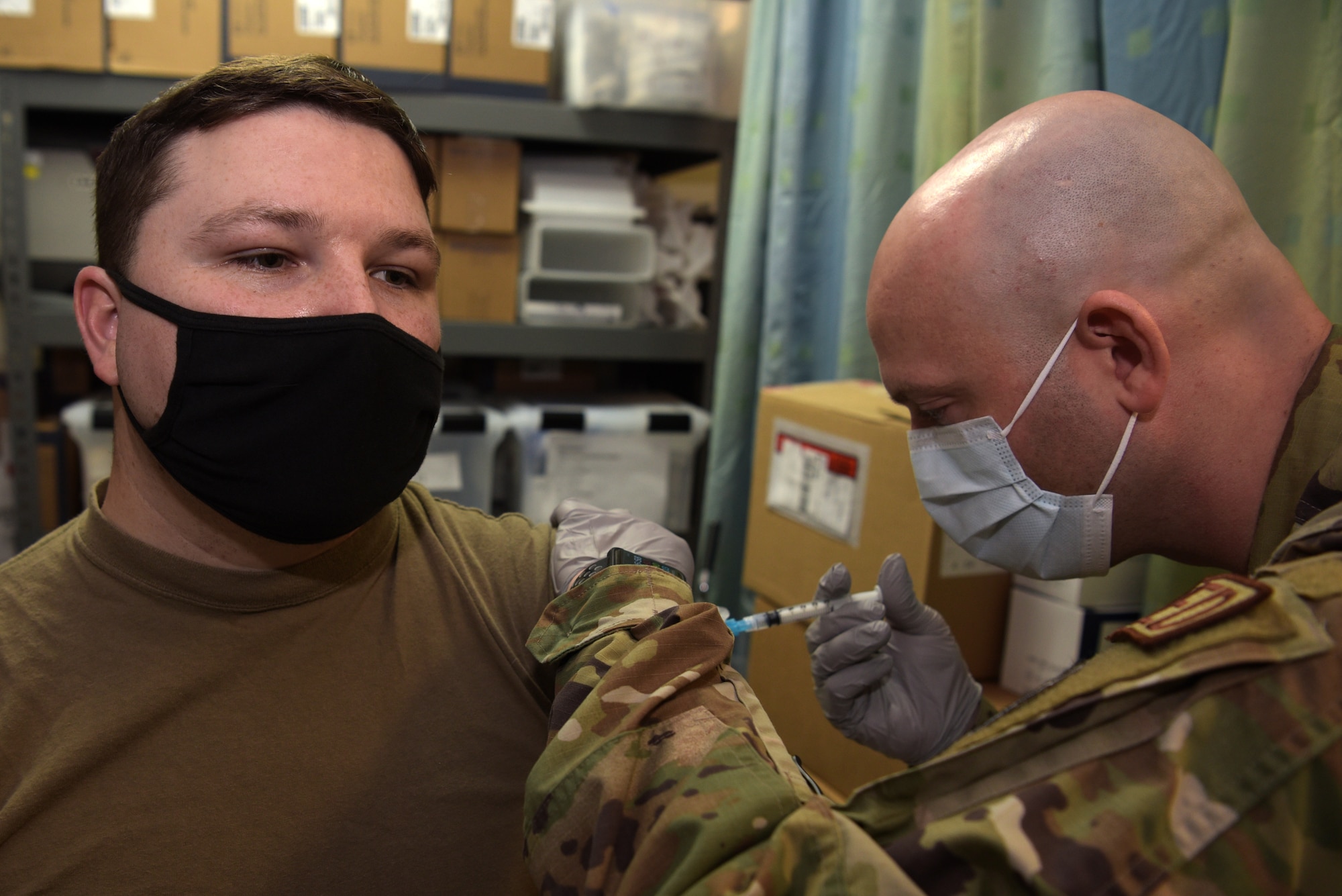 An Airmen receives a shot.