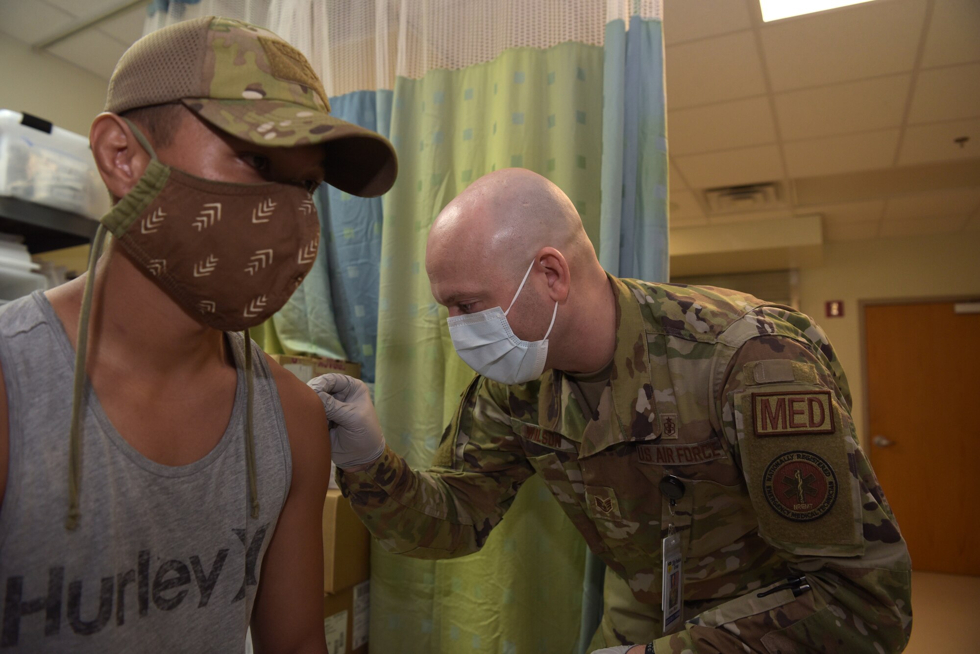 An airmen sanitizes an arm