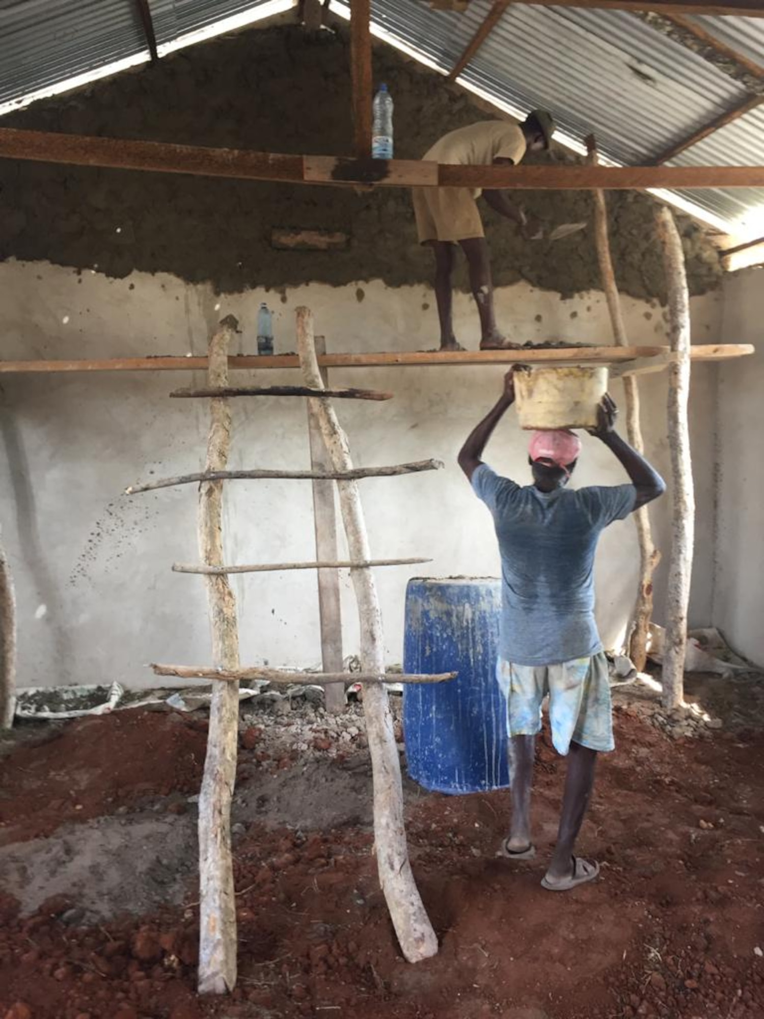 Kenyan volunteers work to expand the primary school in Magogoni Village, Lamu, Kenya, Dec. 23, 2020.