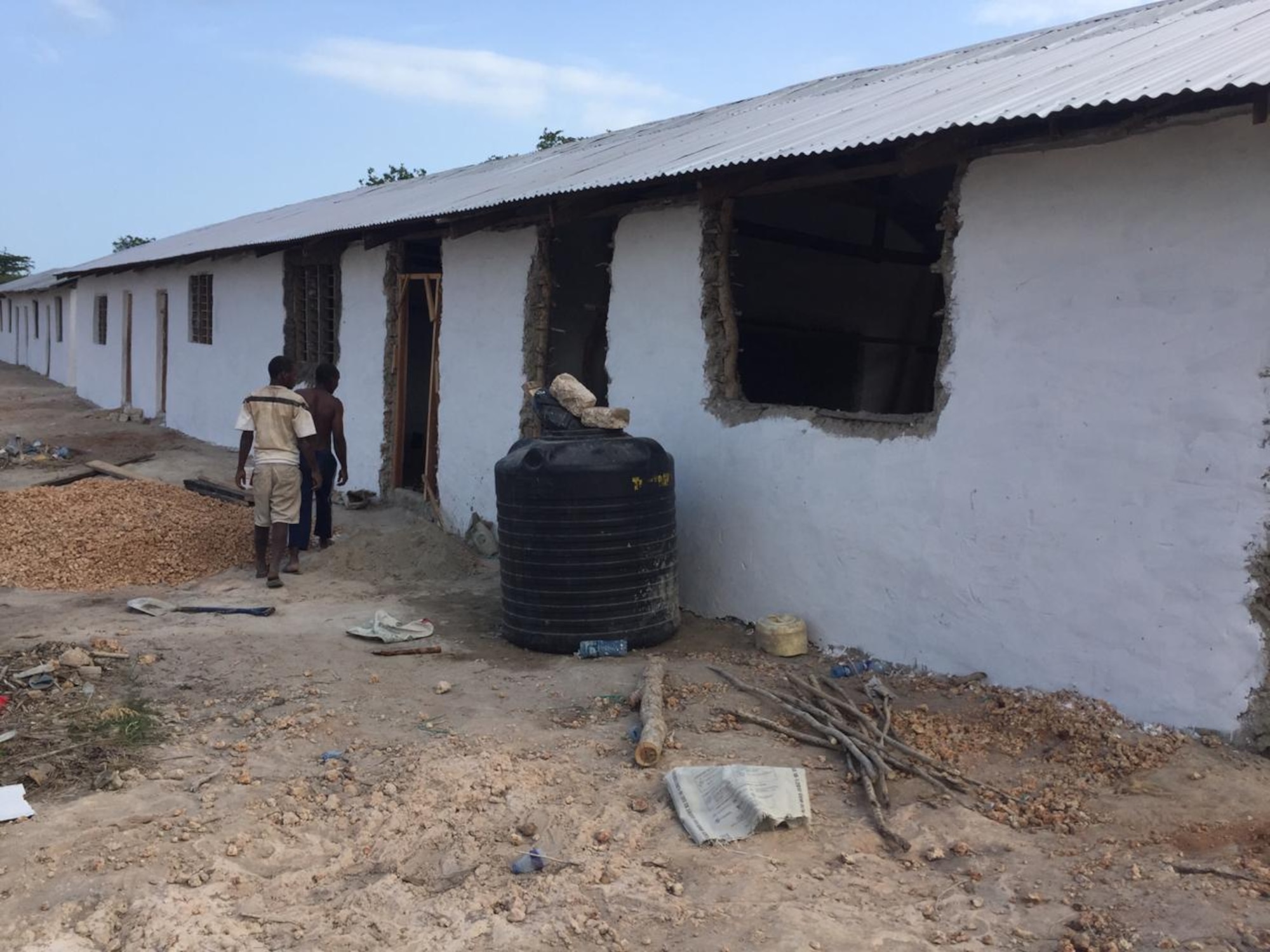 Kenyan volunteers prepare to start another day of work expanding the primary school in Magogoni Village, Lamu, Kenya, Jan. 9, 2021.