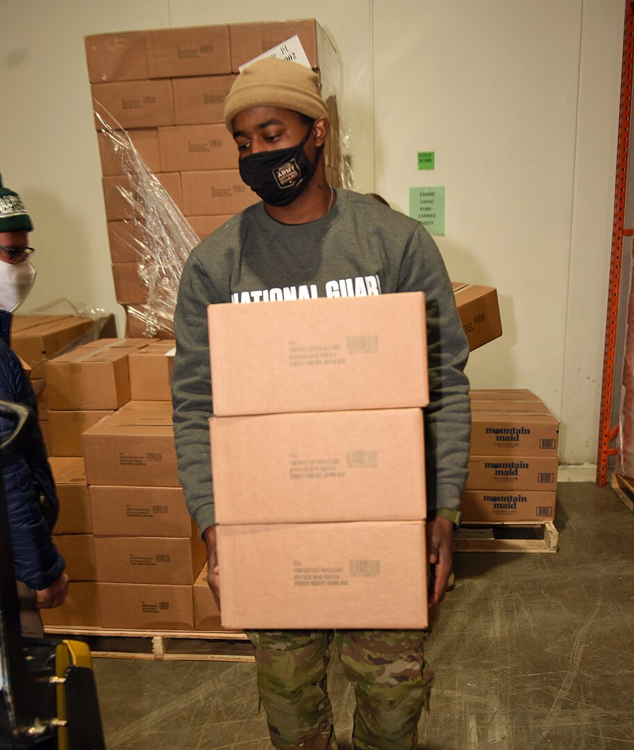 U.S. Army Pfc. Antonio Lyte, a defender with the Taylor Armory, Michigan Army National Guard, works with a new team of National Guard Soldiers filling food orders for charities at Gleaners of Detroit Community Food Bank, Jan. 11, 2021. The food bank warehouse serves 400 agencies in five counties.
