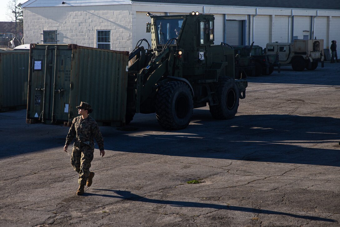 U.S. Marine Corps Sgt. Anthonette Bement, an embarkation specialist with the 26th Marine Expeditionary Unit, ground guides a forklift.