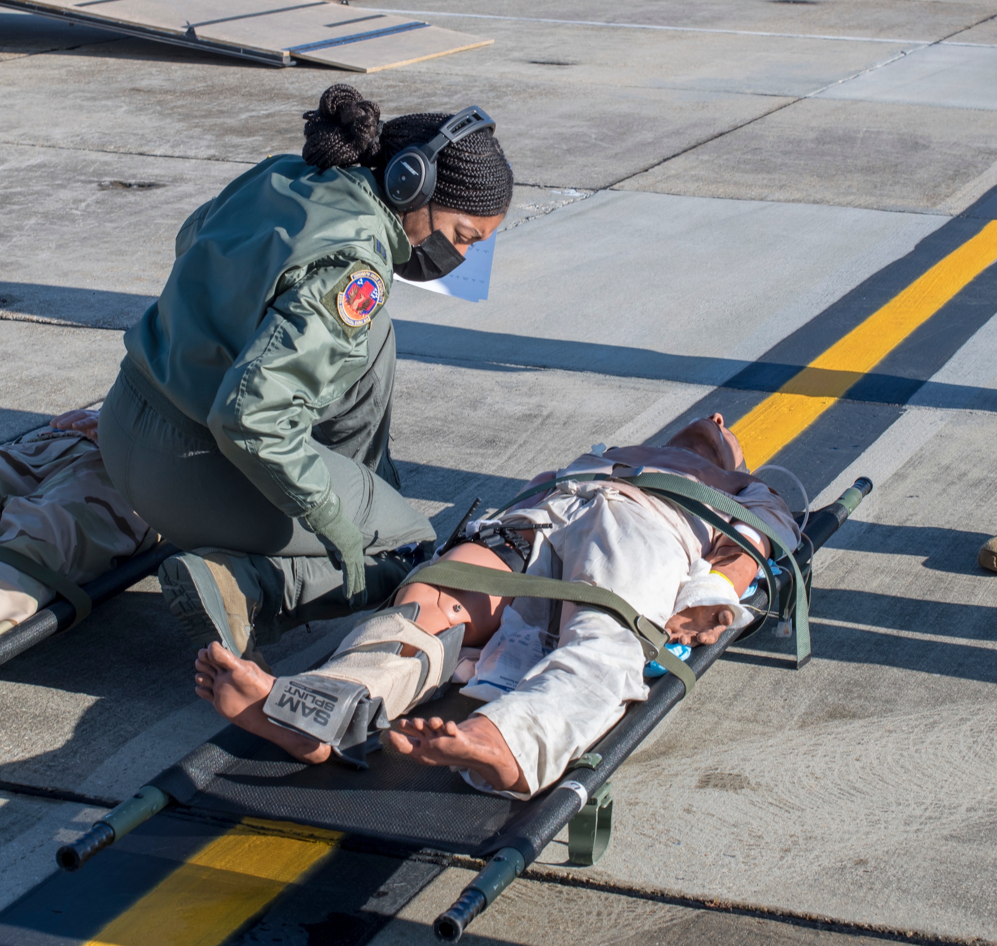Capt. Toya Williams, 36th Aeromedical Evacuation Squadron flight nurse, tends to a "patient" during aeromedical evacuation training at Keesler Air Force Base, Miss., Jan. 13, 2021. Williams is a traditional reservist who, in the civilian world, works as a travel nurse based out of Los Angeles. (U.S. Air Force photo by Senior Airman Kristen Pittman)