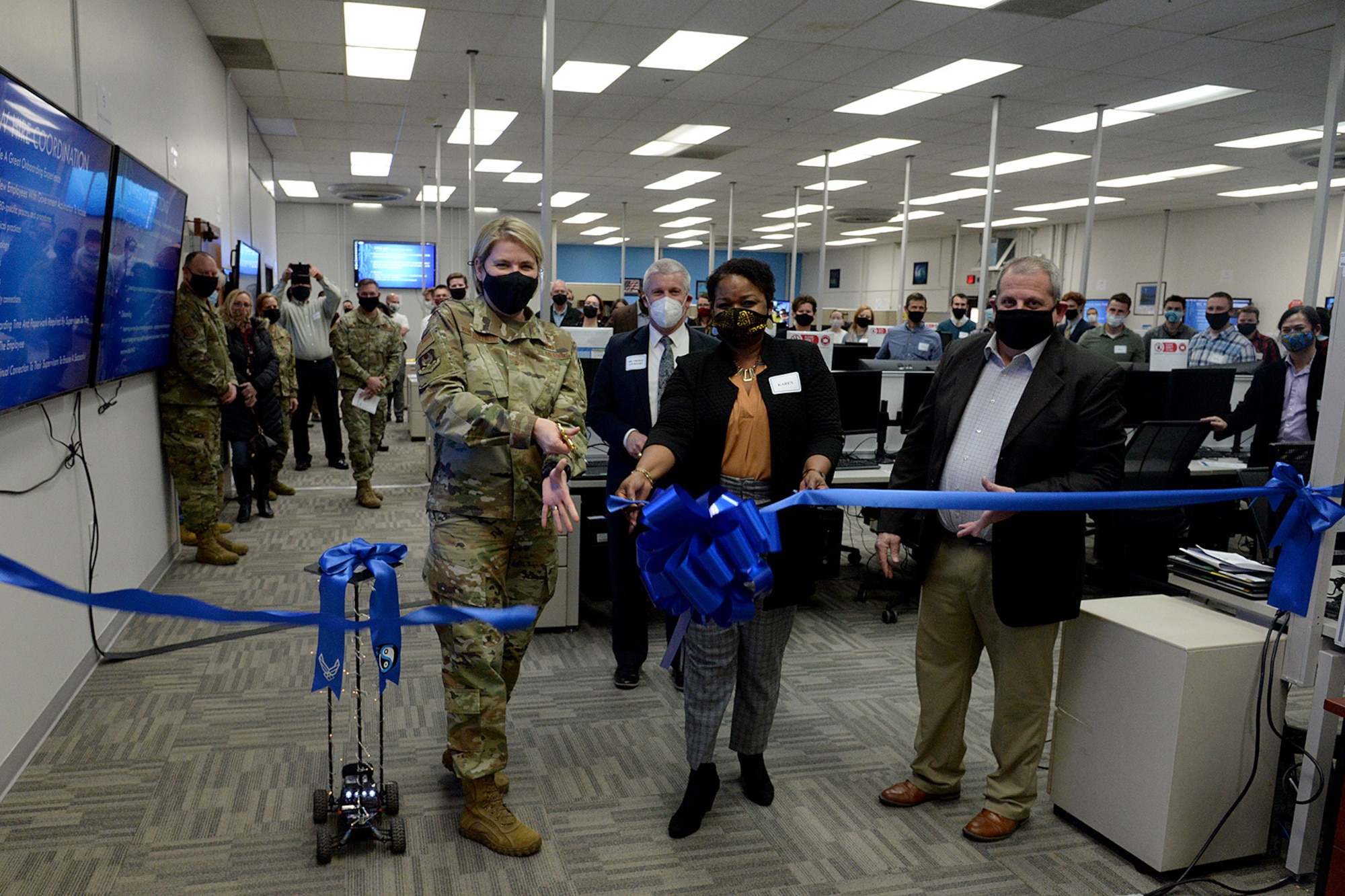 (Left to right) Brig. Gen. Cauley von Hoffman, Ogden Air Logistics Complex commander, Karen Fairclough, Software Organizational Development Office section chief, and Jim Diamond, 309th Software Engineering Group director, cutting the ribbon.