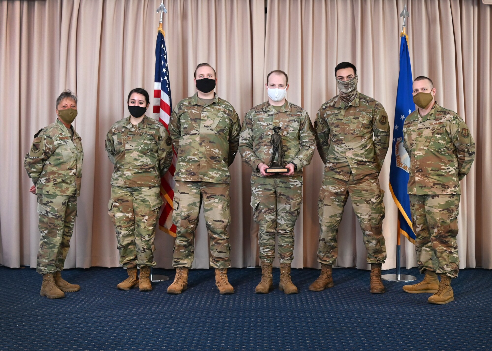 Col. Katrina Stephens, 66th Air Base Group commander, and Chief Master Sgt. Bill Hebb, 66 ABG command chief, present the 66th Medical Squadron Public Health team with the 2020 Small Team of the Year award at Hanscom Air Force Base, Mass., Jan 20.
