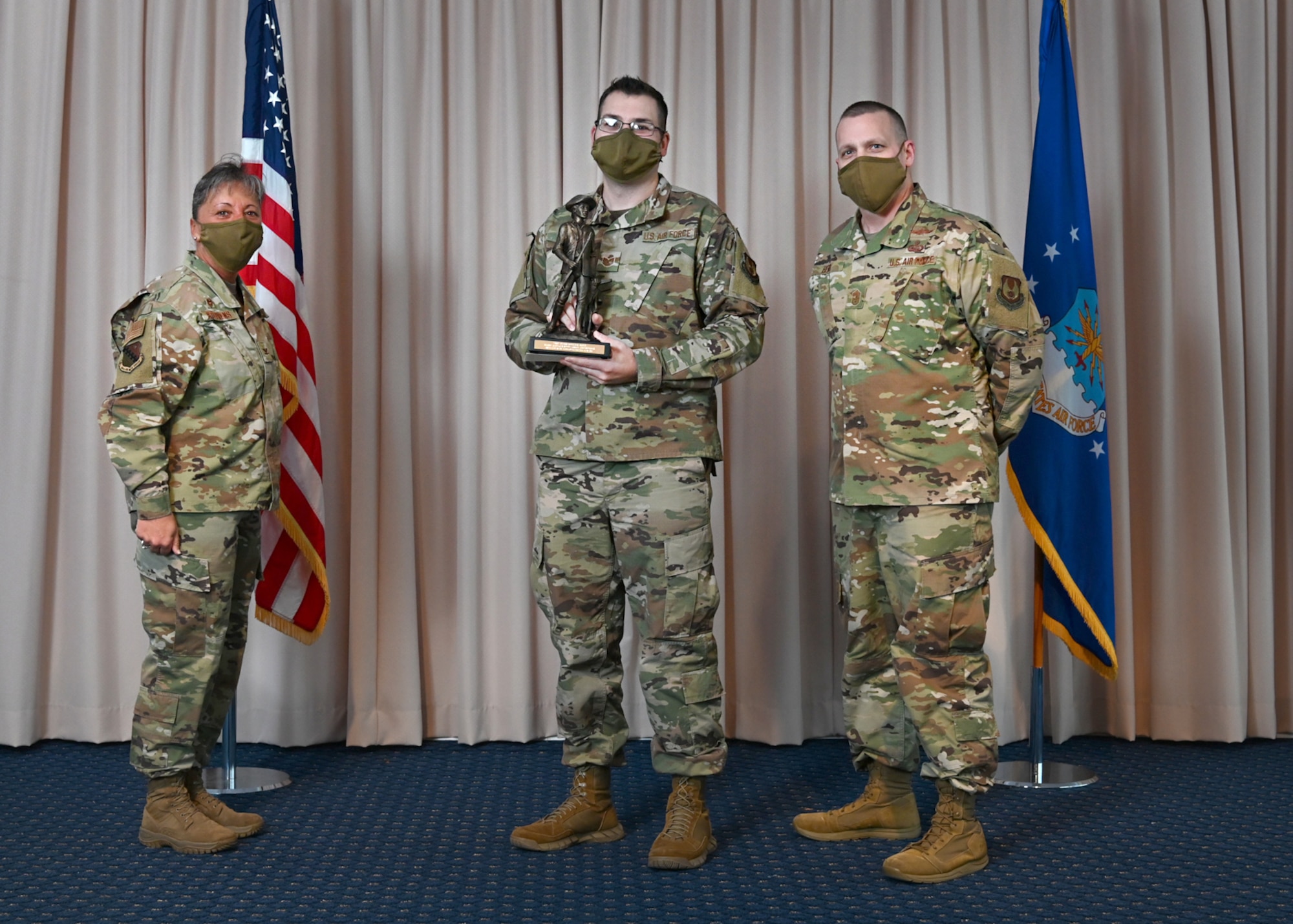 Col. Katrina Stephens, 66th Air Base Group commander, and Chief Master Sgt. Bill Hebb, 66 ABG command chief, present Tech. Sgt. Christopher Boyd, 66 ABG unit deployment manager, with the Chief Master Sgt. Bobby Jacques Spirit Above and Beyond Award at Hanscom Air Force Base, Mass., Jan 20.