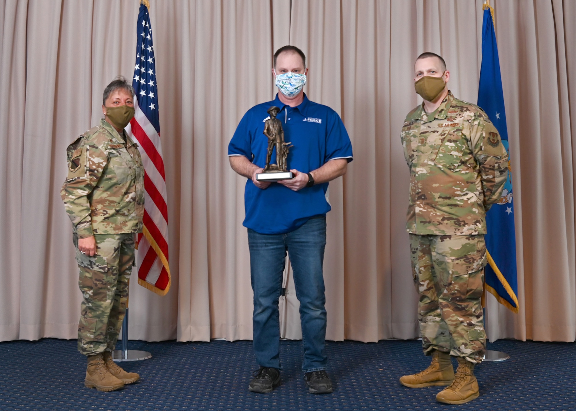 Col. Katrina Stephens, 66th Air Base Group commander, and Chief Master Sgt. Bill Hebb, 66 ABG command chief, Rodmen Hill, 66th Force Support Squadron Aero Club specialist, with the 2020 Nonappropriated Fund Category 1 of the Year award at Hanscom Air Force Base, Mass., Jan 20.