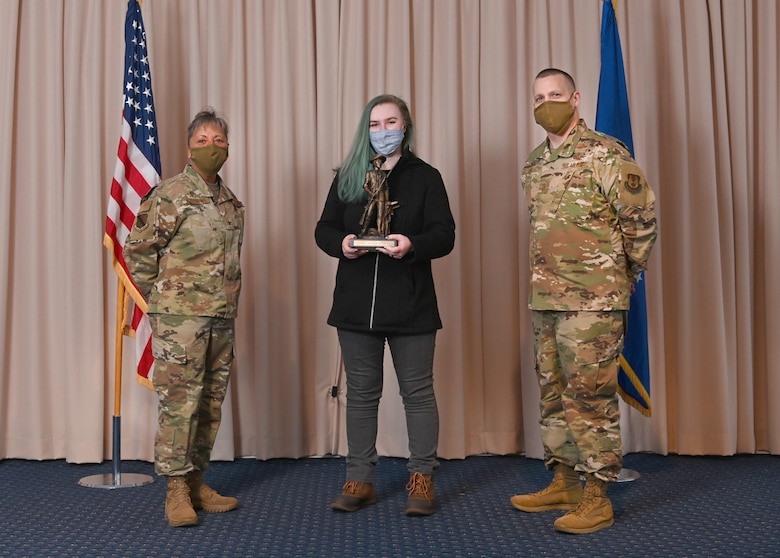 Col. Katrina Stephens, 66th Air Base Group commander, and Chief Master Sgt. Bill Hebb, 66 ABG command chief, present Caitlin Lambour, 66th Force Support Squadron Outdoor Recreation specialist, with the 2020 Nonappropriated Fund Category 1 of the Year award at Hanscom Air Force Base, Mass., Jan 20.