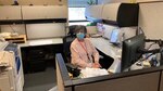 Linda Bumgarner posse for a picture at her desk