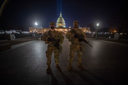 Oklahoma Army National Guard members and brothers Sgt. Kade Silvers, right, and Sgt. Korbin Silvers, both of Enid, Oklahoma, pose at the U.S. Capitol building before beginning their shift monitoring the inner ring of security around the Capitol, Jan. 19, 2021. At least 25,000 National Guard men and women have been authorized to conduct security, communication and logistical missions in support of federal and District authorities leading up to and through the 59th Presidential Inauguration. (U.S. National Guard photo by Sgt. Anthony Jones)