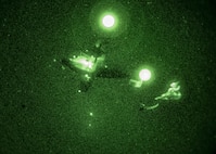 A C-145A Skytruck drops a hand-toss bag rigged to a parachute as part of an aerial delivery training exercise on the Eglin Range, Florida on Jan. 6, 2021.
