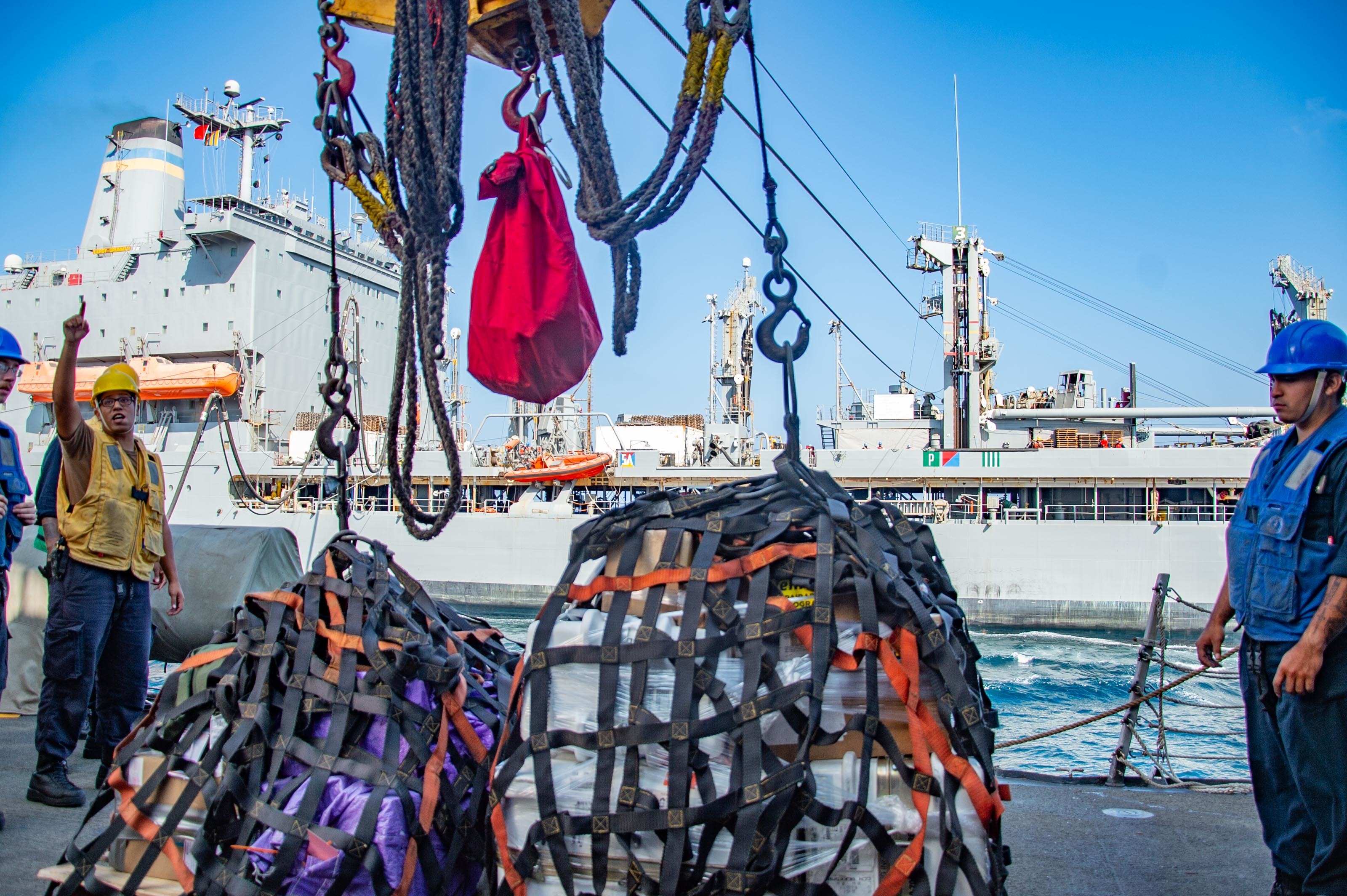 Sailors aboard guided-missile destroyer USS Winston S. Churchill (DDG 81) prepare to send pallets to fleet replenishment oiler USNS Leroy Grumman (T-AO 195) during a replenishment-at-sea.