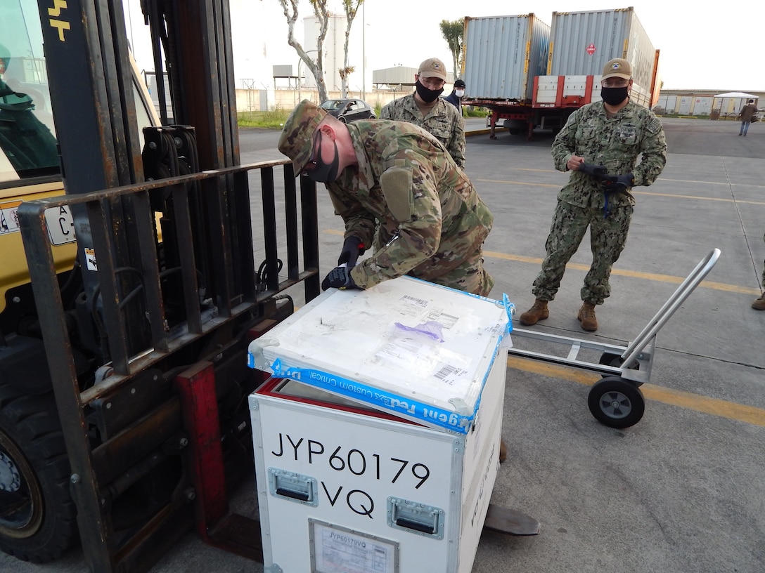 US Troop opens package of COVID-19 vaccine shipment