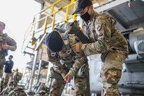 U.S. Army Reserve Paratroopers with the 404th Civil Affairs Battalion and the 450th Civil Affairs Battalion, U.S. Army Civil Affairs & Psychological Operations Command (Airborne), prepare to conduct airborne operations at Joint Base McGuire-Dix-Lakehurst, N.J., Jan. 8, 2021. The units conducted non-tactical airborne operations in order to maintain mission readiness and proficiency among their paratroopers.