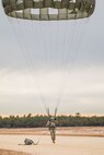 A U.S. Army Reserve Paratrooper navigates the winds during an airborne operation conducted by the 404th Civil Affairs Battalion and the 450th Civil Affairs Battalion, U.S. Army Civil Affairs & Psychological Operations Command (Airborne) at Joint Base McGuire-Dix-Lakehurst, N.J., Jan. 8, 2021. The unit conducted non-tactical airborne operations in order to maintain mission readiness and proficiency among their paratroopers.