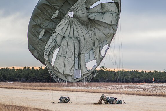 A U.S. Army Reserve Paratrooper comes to a safe landing during an airborne operation conducted by the 404th Civil Affairs Battalion and the 450th Civil Affairs Battalion, U.S. Army Civil Affairs & Psychological Operations Command (Airborne) at Joint Base McGuire-Dix-Lakehurst, N.J., Jan. 8, 2021. The unit conducted non-tactical airborne operations in order to maintain mission readiness and proficiency among their paratroopers.