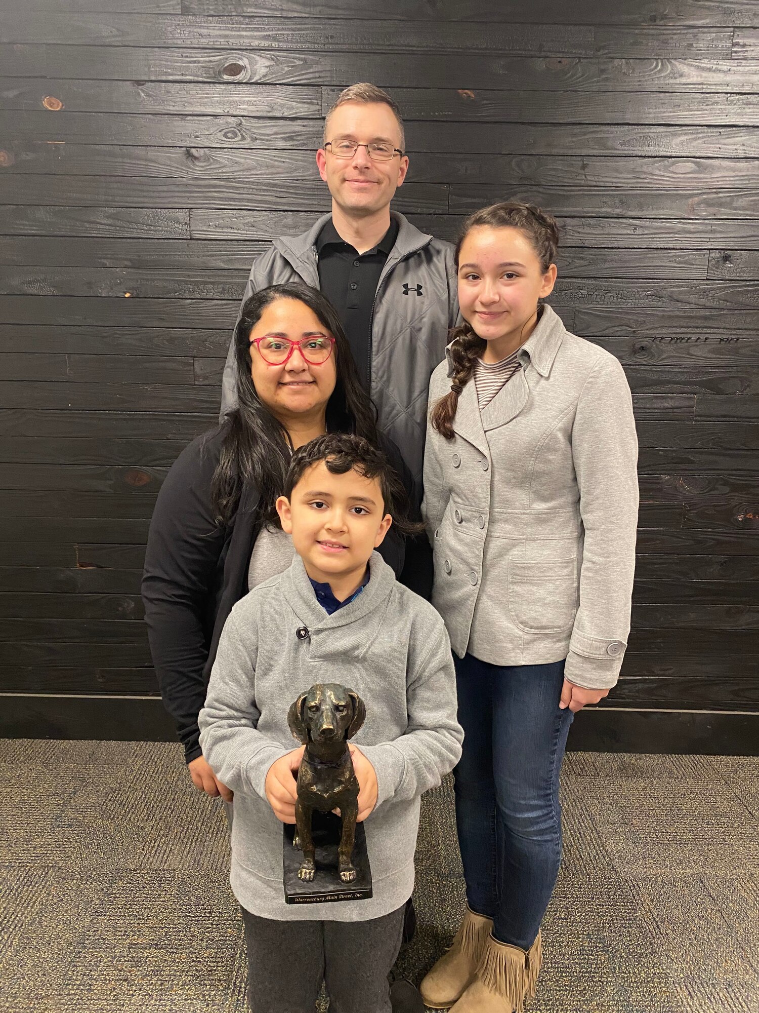 U.S. Air Force Master Sgt. Brandon Mitcheltree, his wife Monica and their children, present their “Heart of Downtown” trophy they received from Warrensburg Main Street Inc. for their community volunteer efforts, Jan. 14, 2021, in Warrensburg, Mo. Mitcheltree is the 509th Bomb Wing Inspector General superintendent at Whiteman Air Force Base. (Courtesy photo by Warrensburg Main Street Inc.)