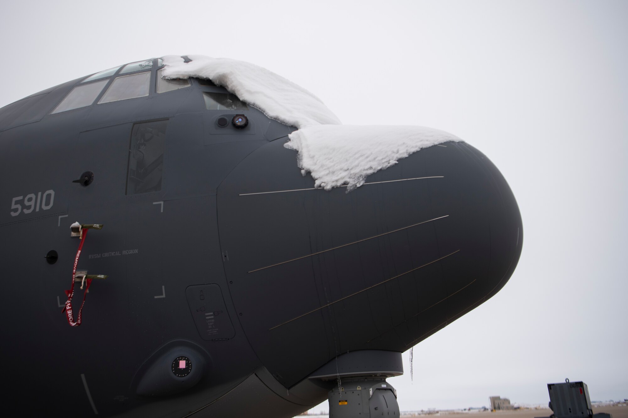 Snow lays on the nose of an AC-130 Whiskey