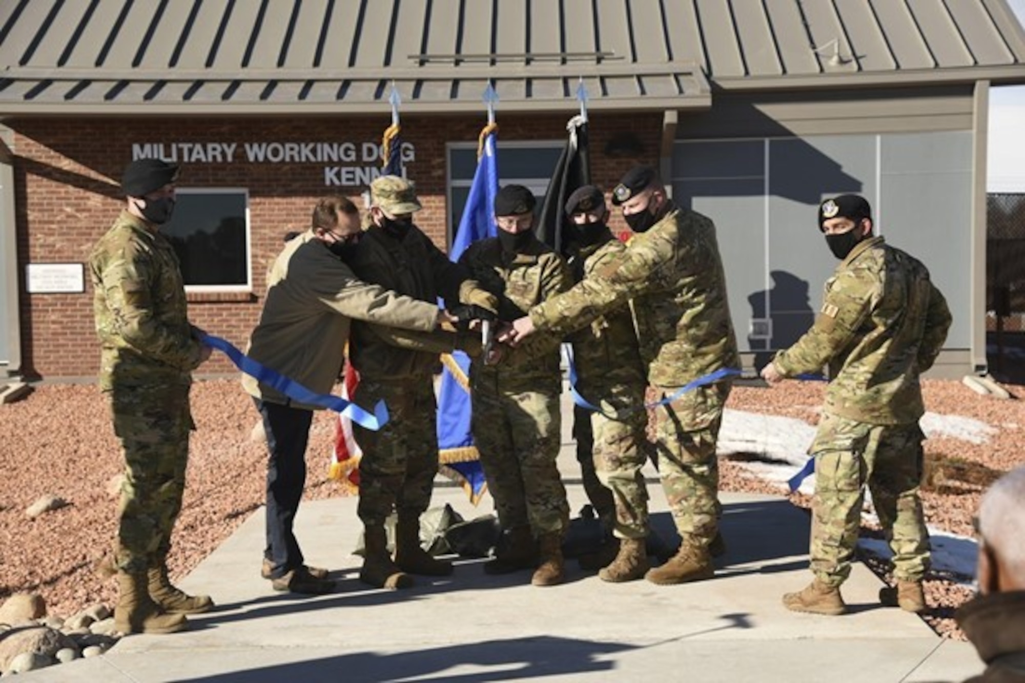 Group of people cutting a ribbon