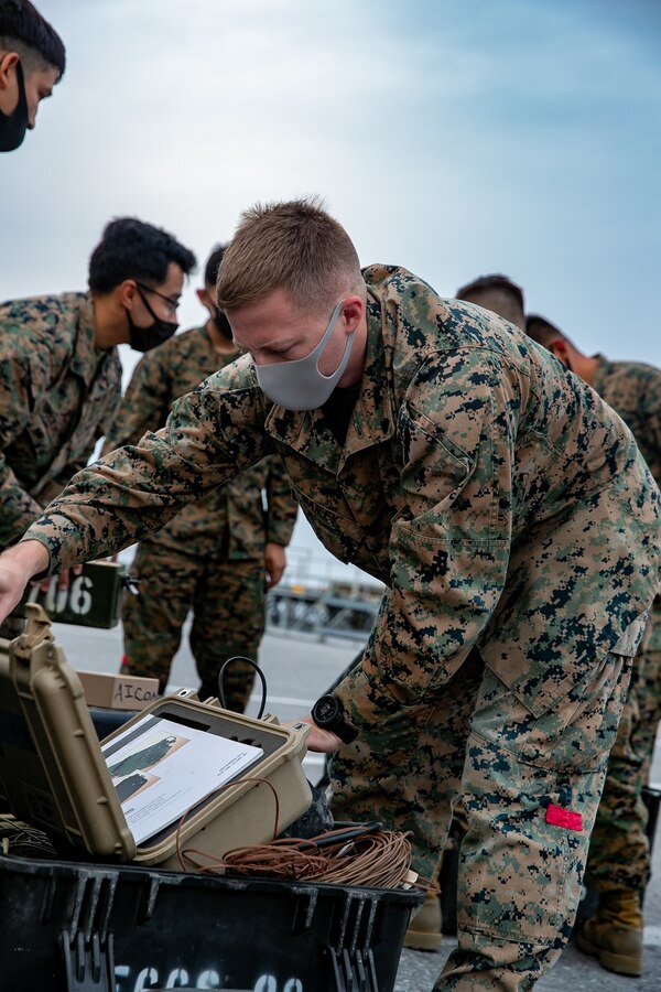 U.S. Marine Corps Cpl. Ashton Bailey, a landing support specialist with 3rd Landing Support Battalion, 3rd Marine Logistics Group, checks hazardous materials for the palletized gear during deployment preparation on Kadena Air Force Base, Okinawa, Japan, Jan. 21, 2021. 3rd MEB practices distributed operations as part of the Marine Corps’ only forward-deployed force. (U.S. Marine Corps photo by Lance Cpl. Natalie Greenwood)